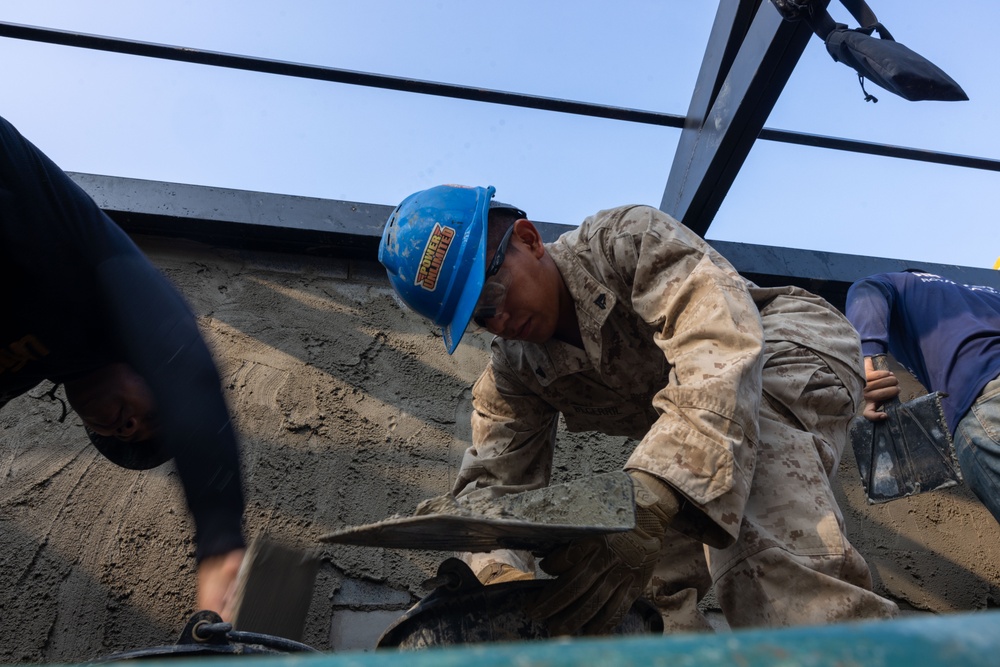 Cobra Gold 24; Marines with Marine Wing Support Squadron 171 apply stucco at the Ban Prakaet School