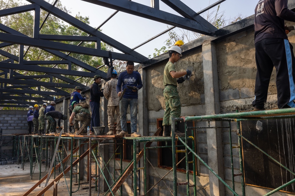 Cobra Gold 24; Marines with Marine Wing Support Squadron 171 apply stucco at the Ban Prakaet School