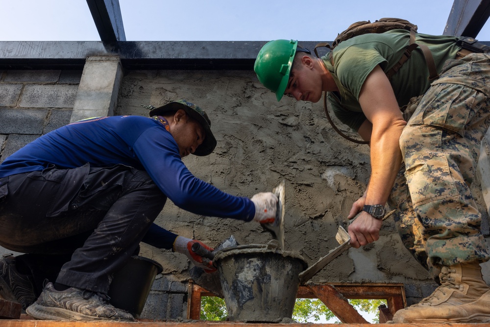 Cobra Gold 24; Marines with Marine Wing Support Squadron 171 apply stucco at the Ban Prakaet School