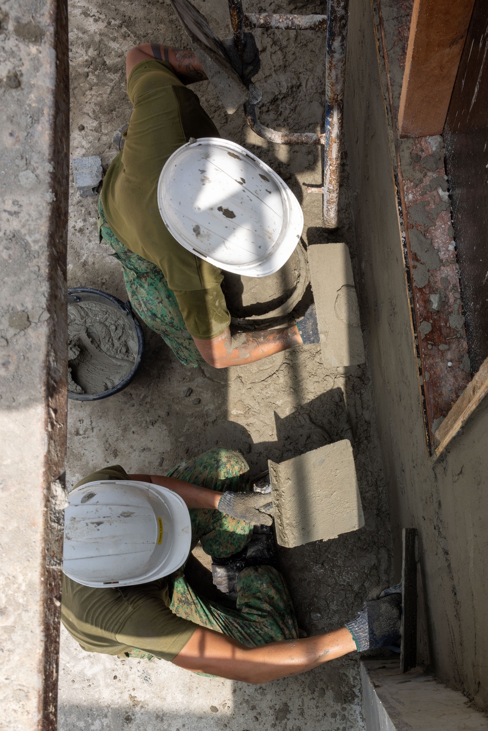 Cobra Gold 24; Marines with Marine Wing Support Squadron 171 apply stucco at the Ban Prakaet School