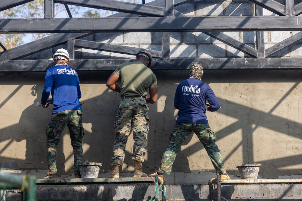 Cobra Gold 24; Marines with Marine Wing Support Squadron 171 apply stucco at the Ban Prakaet School