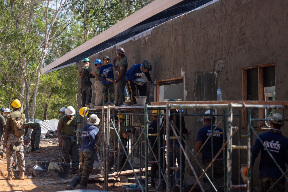 Cobra Gold 24; Marines with Marine Wing Support Squadron 171 apply stucco at the Ban Prakaet School