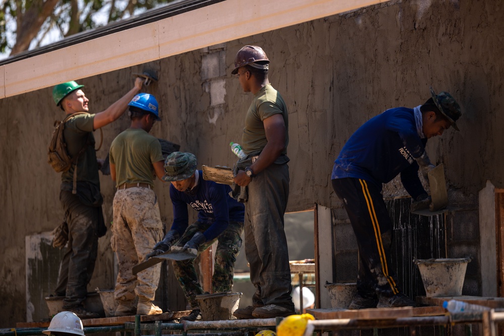 Cobra Gold 24; MWSS 171 Marines with Marine Wing Support Squadron 171 apply stucco at the Ban Prakaet School