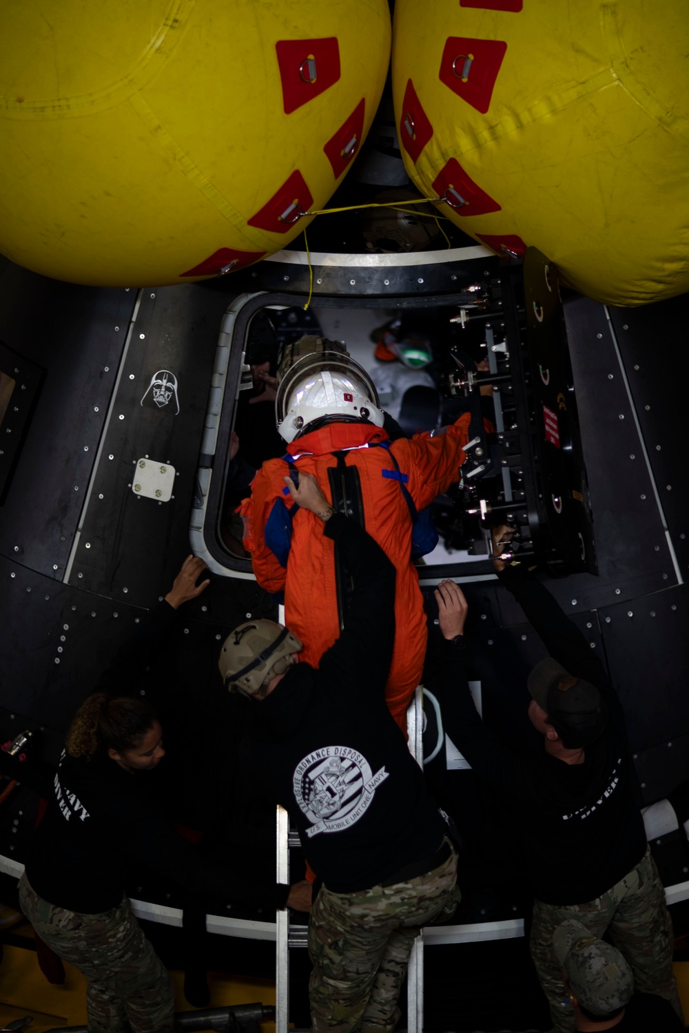 Astronauts run drills in a crew module test article aboard USS San Diego while underway for NASA’s Underway Recovery Test 11