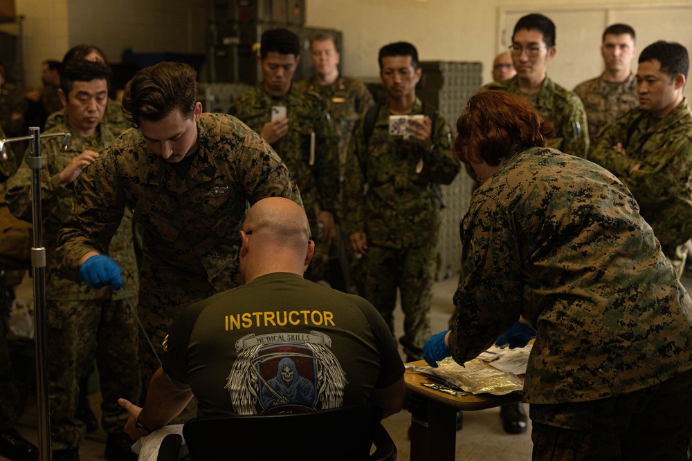 U.S. Navy Corpsman with 3rd Medical Battalion demonstrate a blood transfusion for the Japanese Ground Self Defense Force