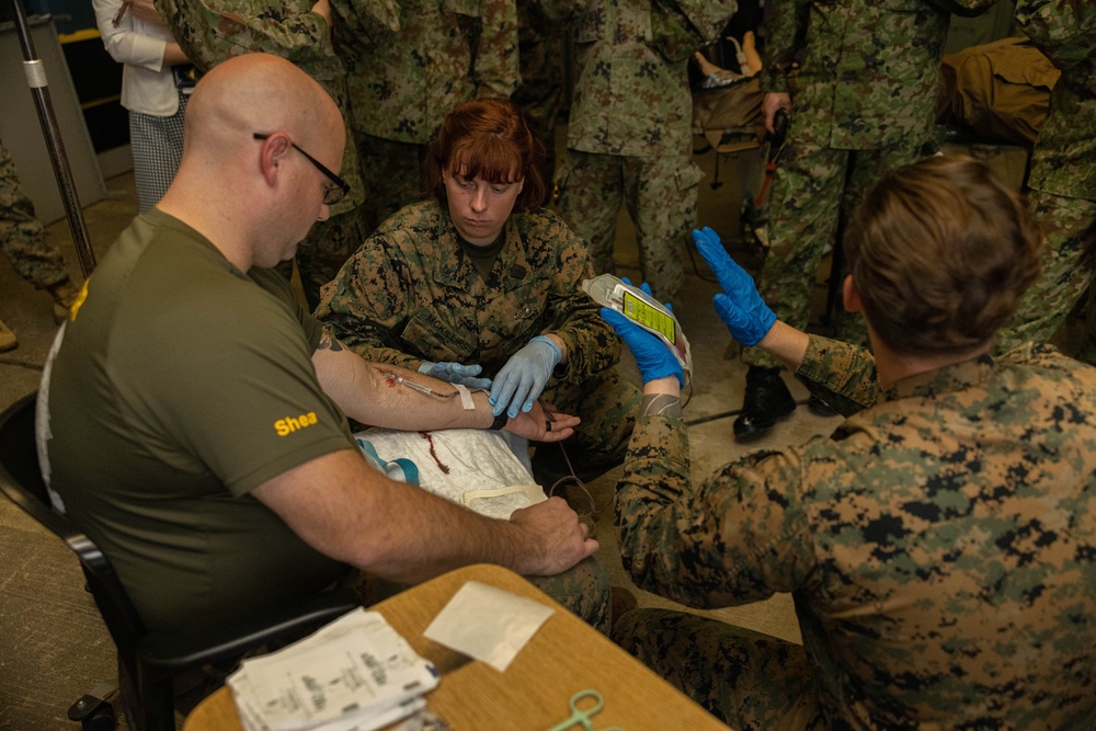 U.S. Navy Corpsman with 3rd Medical Battalion demonstrate a blood transfusion for the Japanese Ground Self Defense Force