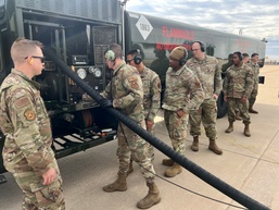 Airmen transfer fuel to aircraft