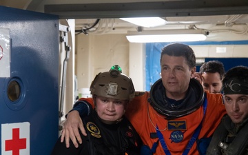 Helicopter Sea Combat Squadron 23 Sailors assist astronauts to medical facilities during Underway Recovery Test 11