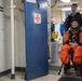 Helicopter Sea Combat Squadron 23 Sailor assists astronauts to medical facilities during Underway Recovery Test 11