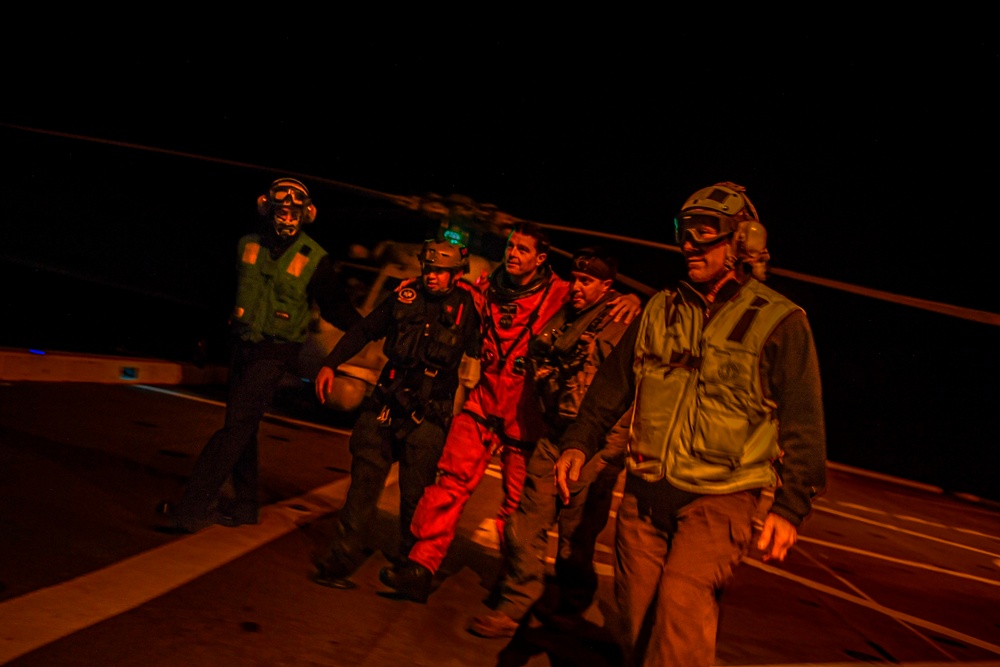 USS San Diego Sailors aid Artemis II crew members during Underway Recovery Test 11