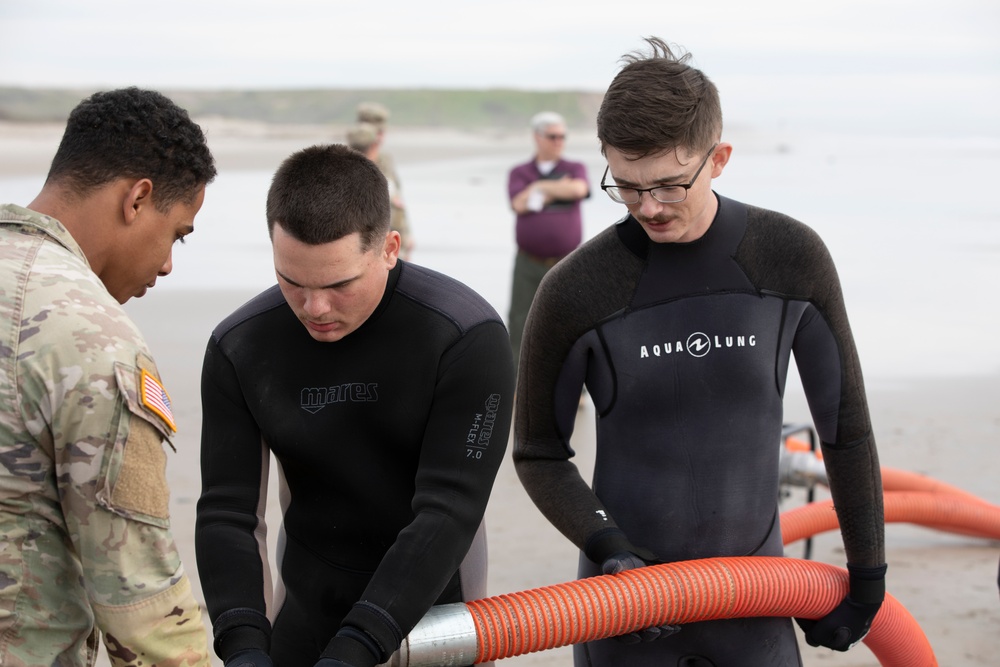 7th Transportation Brigade Soldiers assemble a pump system during Project Convergence Capstone 4 experiments