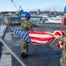 USS Ronald Reagan (CVN 76) Sailors conduct morning colors
