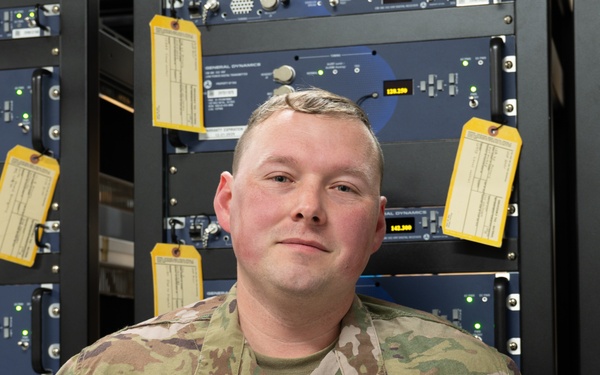 TSgt. Marple Stands in Front of Ground to Air Radios