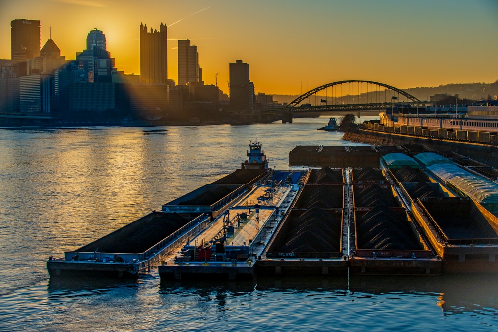 Barge traffic moves through port of Pittsburgh at sunrise