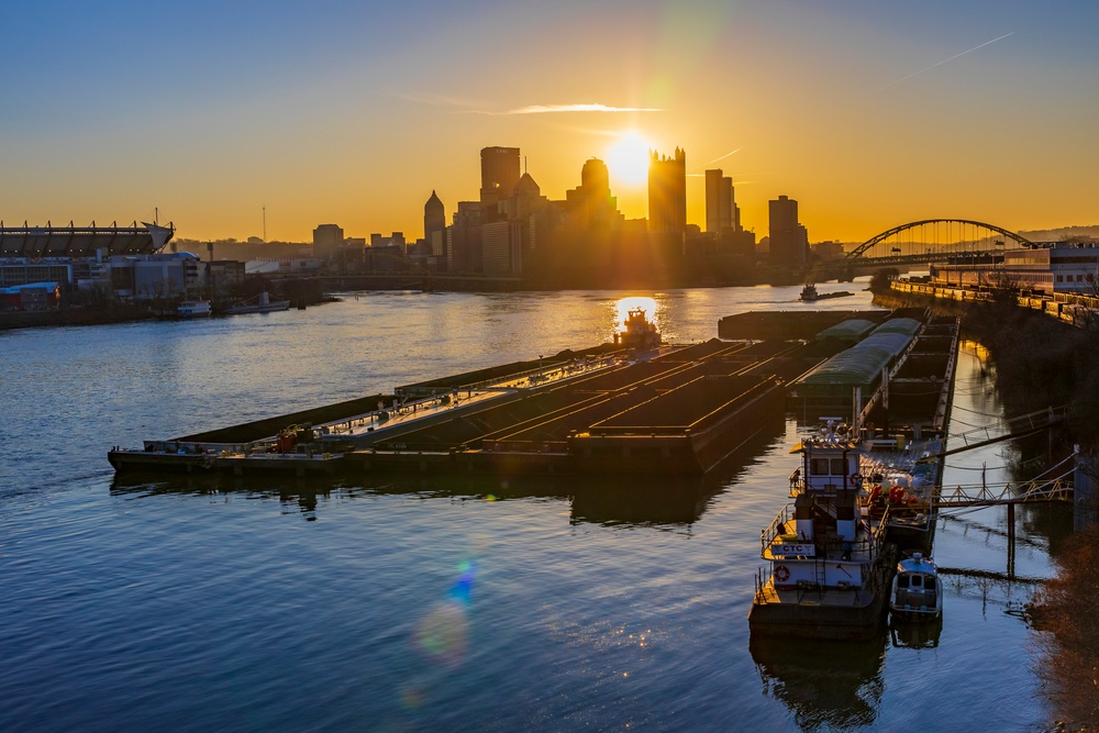 Barge traffic moves through port of Pittsburgh at sunrise