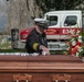 Former Travis Air Force Base fire Chief John Speakman lays a white glove on the casket of  former Travis AFB assistant fire Chief Robert Dittmer