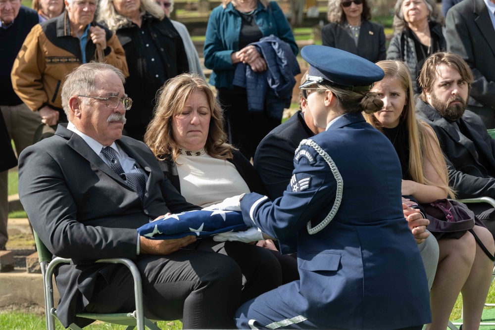 Jeff Dittmer, son of Robert Dittmer, receives the United States flag that covered the casket during his father’s funeral.