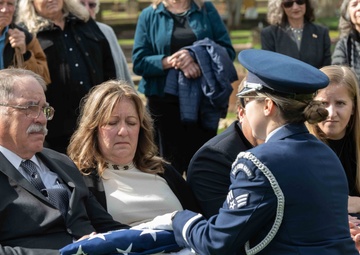 Jeff Dittmer, son of Robert Dittmer, receives the United States flag that covered the casket during his father’s funeral.