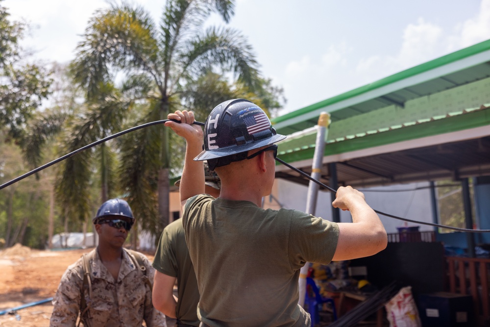 Cobra Gold 24; Marines with Marine Wing Support Squadron 171 work on electrical wiring and concrete prep