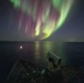 USS Gunston Hall passes under the northern lights during Steadfast Defender 24