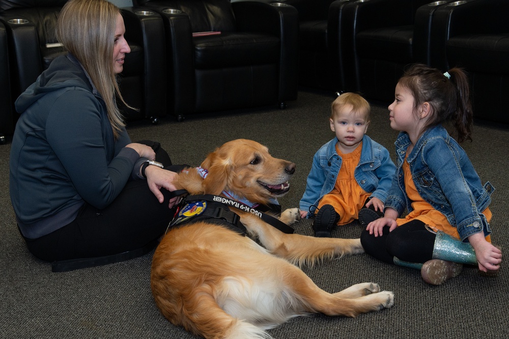 436th AW commander, command chief lead story time at the USO