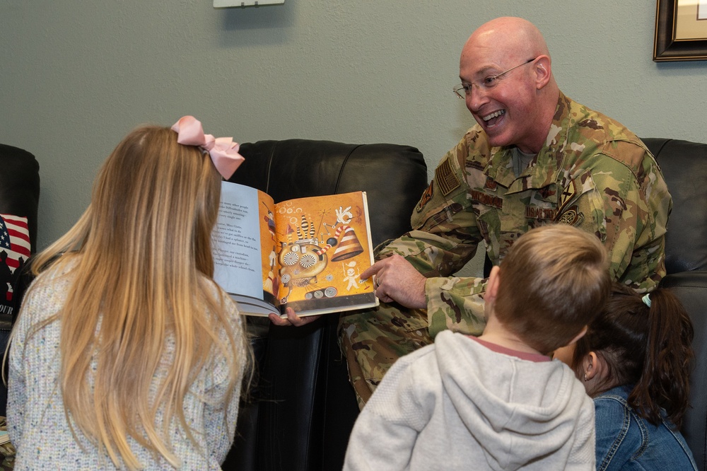 436th AW commander, command chief lead story time at the USO