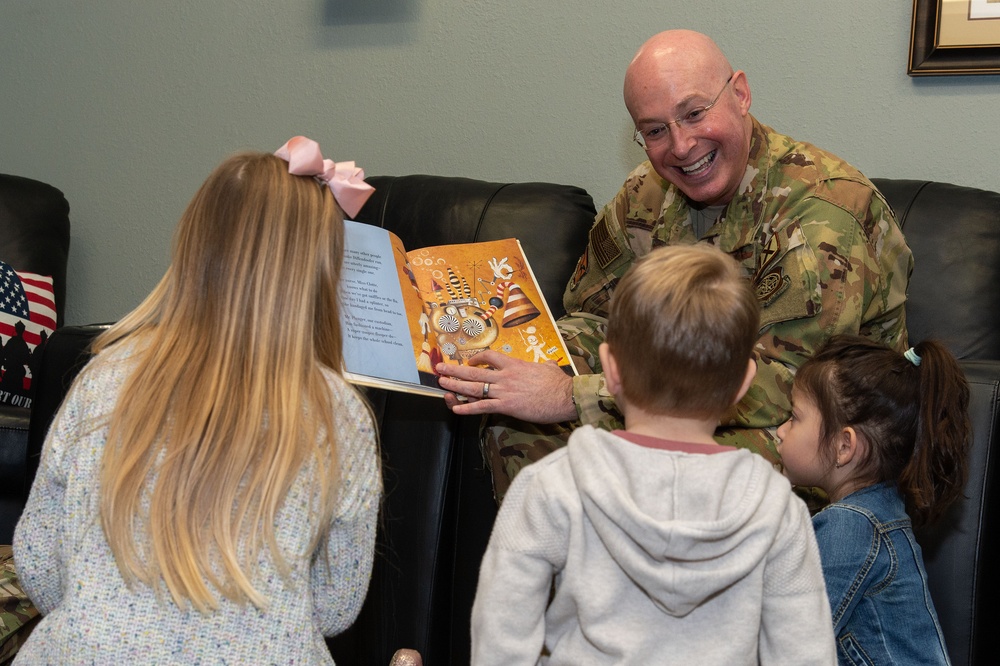 436th AW commander, command chief lead story time at the USO