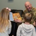 436th AW commander, command chief lead story time at the USO