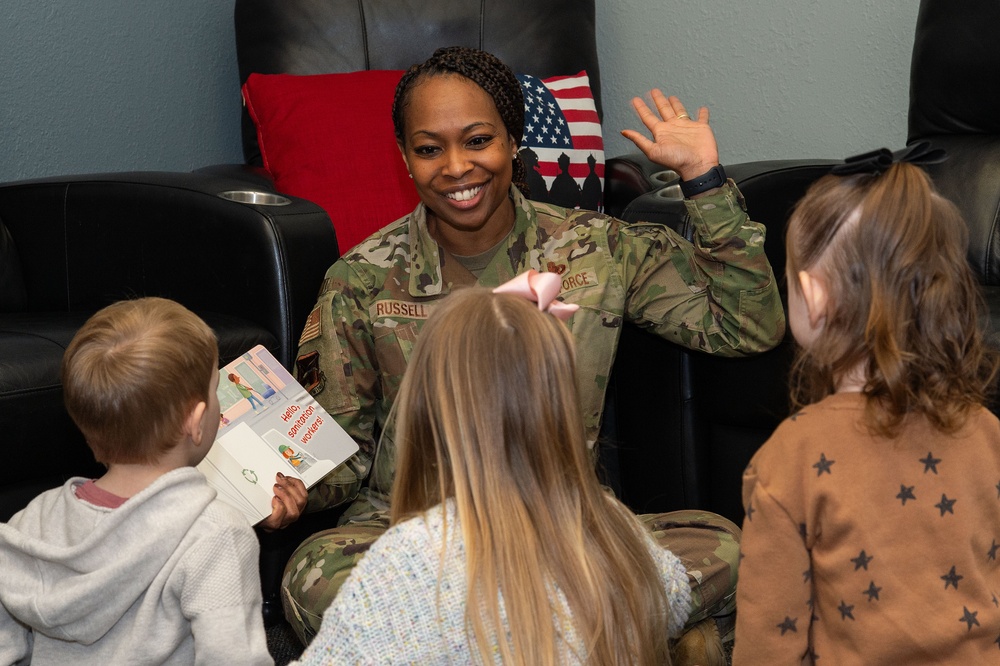 436th AW commander, command chief lead story time at the USO