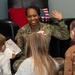 436th AW commander, command chief lead story time at the USO