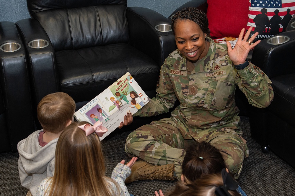 436th AW commander, command chief lead story time at the USO