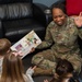 436th AW commander, command chief lead story time at the USO