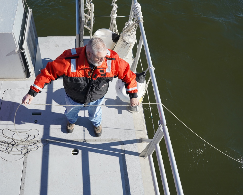 U.S. Army Corps of Engineers small craft survey crew deploys the specialized side sonar system.