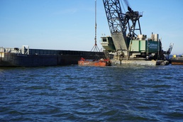 The US Army Corps of Engineers small craft survey crew monitors dredging operations in the Baltimore Harbor.