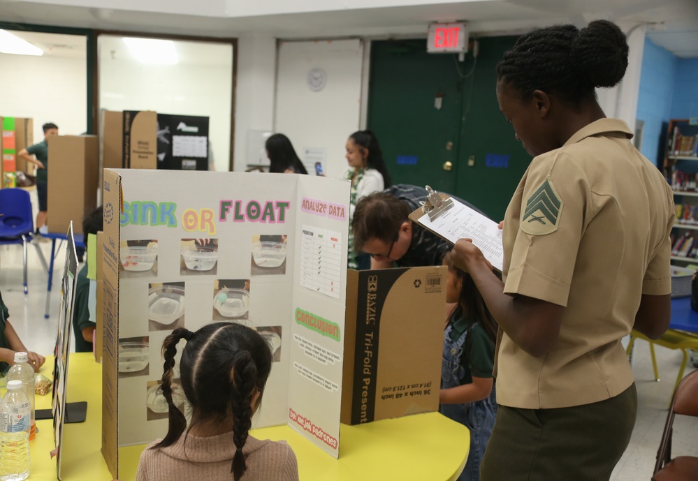 U.S. Marines stationed at Marine Corps Base Camp Blaz volunteer at Finegayan Elementary School science fair