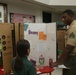 U.S. Marines stationed at Marine Corps Base Camp Blaz volunteer at Finegayan Elementary School science fair