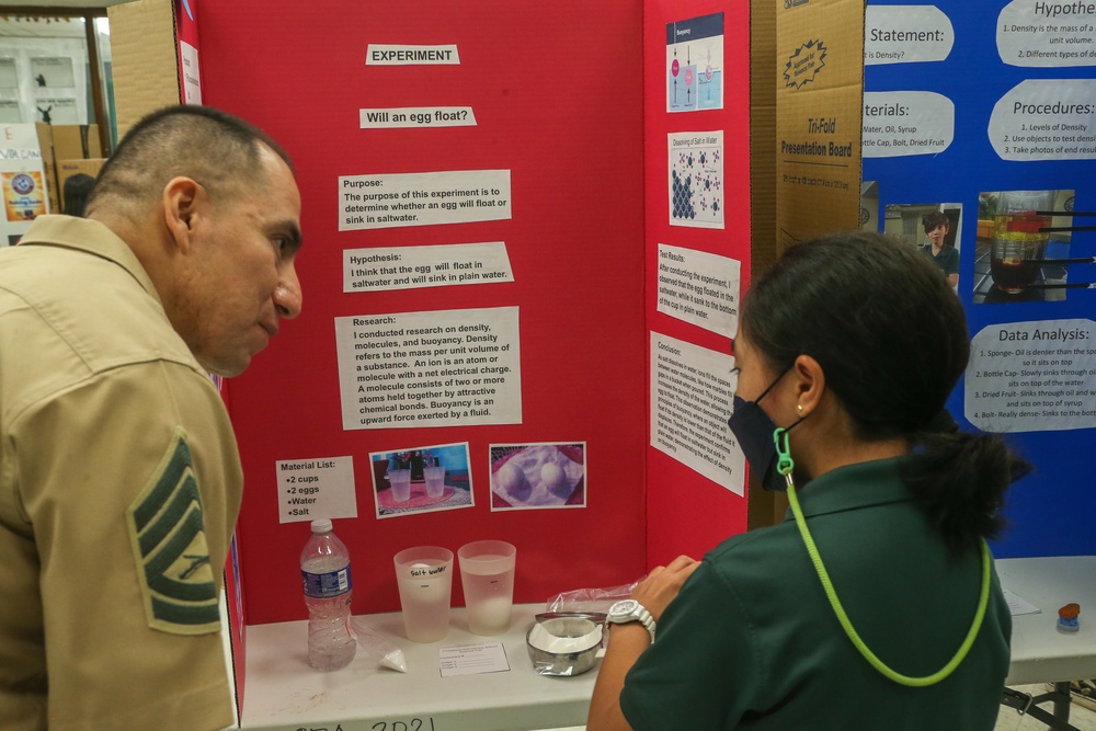 U.S. Marines stationed at Marine Corps Base Camp Blaz volunteer at Finegayan Elementary School science fair