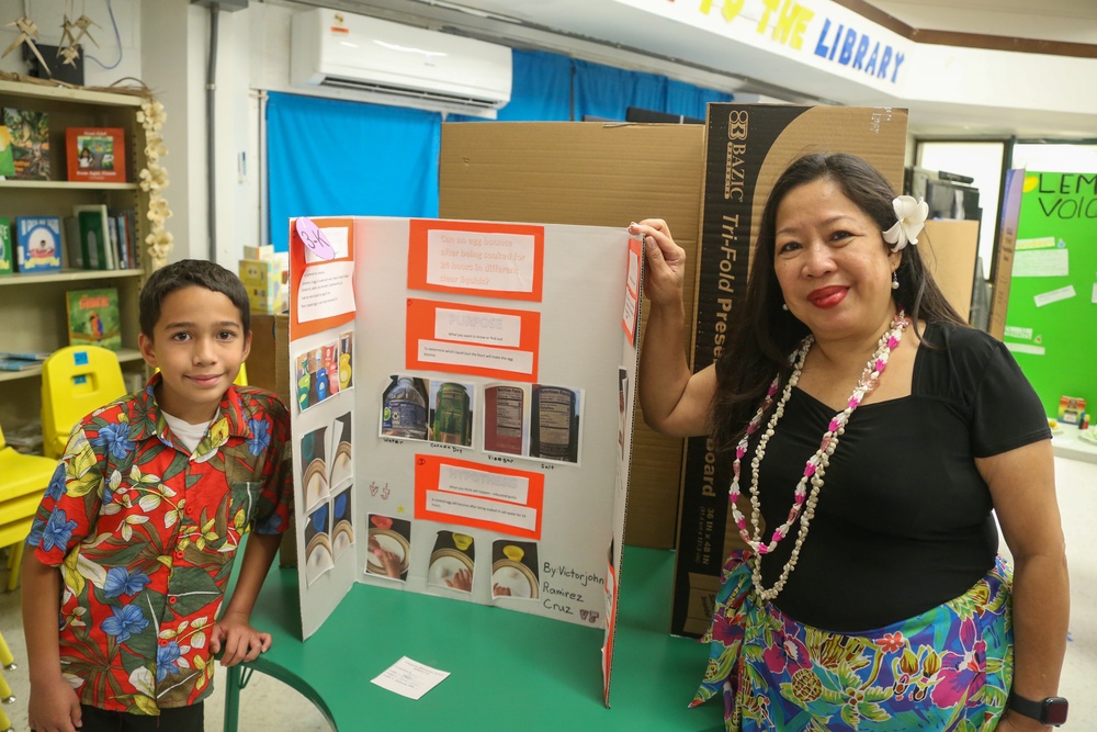 U.S. Marines stationed at Marine Corps Base Camp Blaz volunteer at Finegayan Elementary School science fair