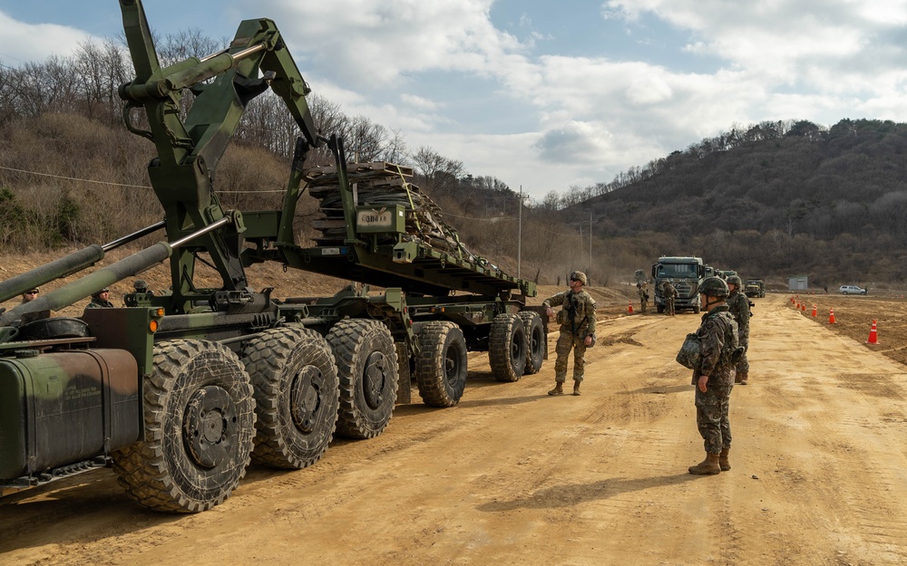 U.S. Soldiers and ROK soldiers unload concertina wire as part of Freedom Shield 24