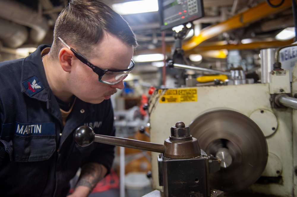 USS Ronald Reagan (CVN 76) Sailors craft a machine part