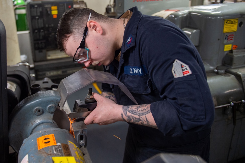 USS Ronald Reagan (CVN 76) Sailors craft a machine part