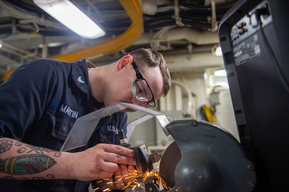 USS Ronald Reagan (CVN 76) Sailors craft a machine part