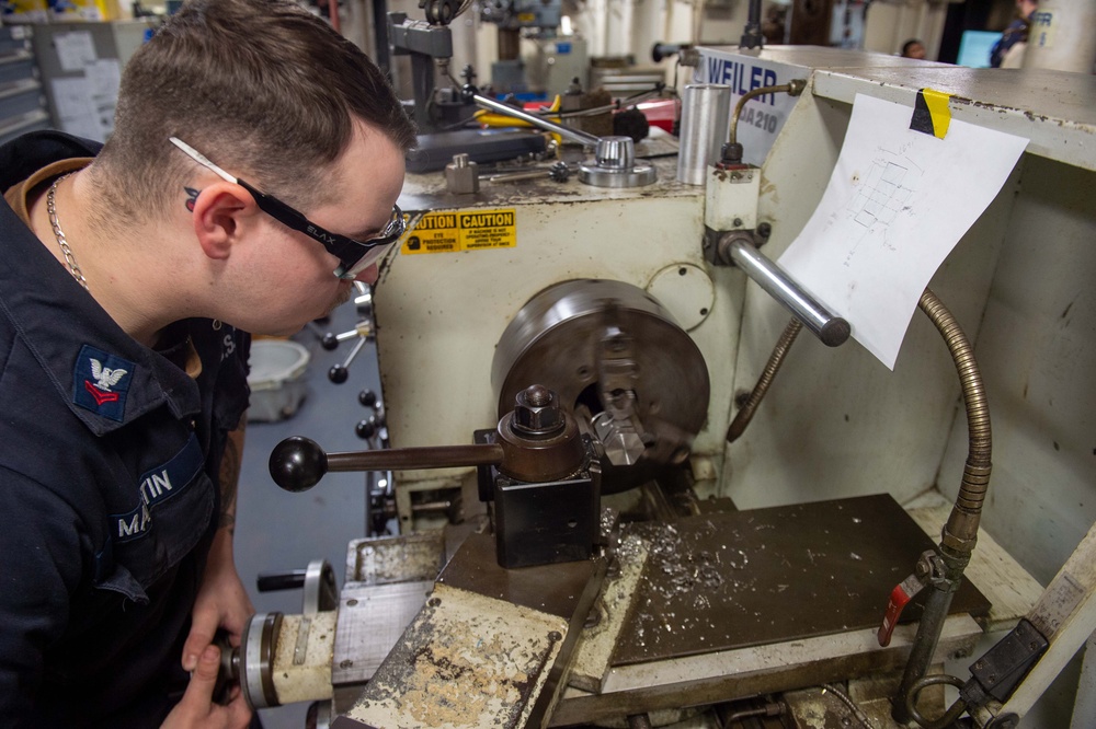 USS Ronald Reagan (CVN 76) Sailors craft a machine part