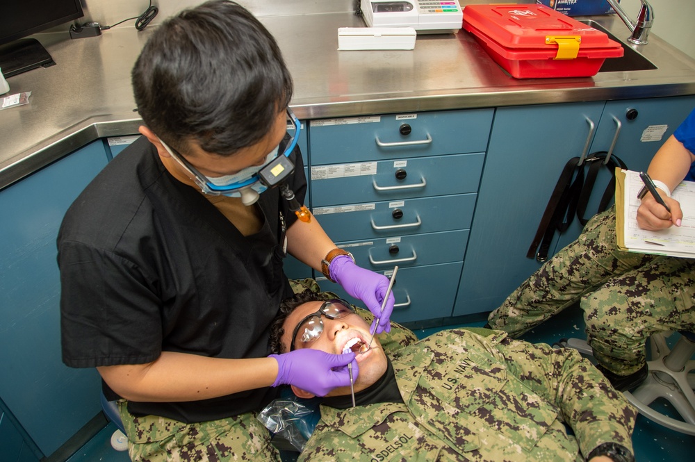 USS Ronald Reagan (CVN 76) Sailors conduct a dental examination