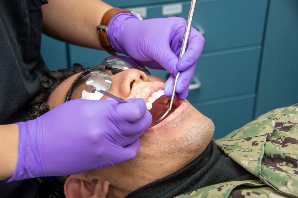 USS Ronald Reagan (CVN 76) Sailors conduct a dental examination