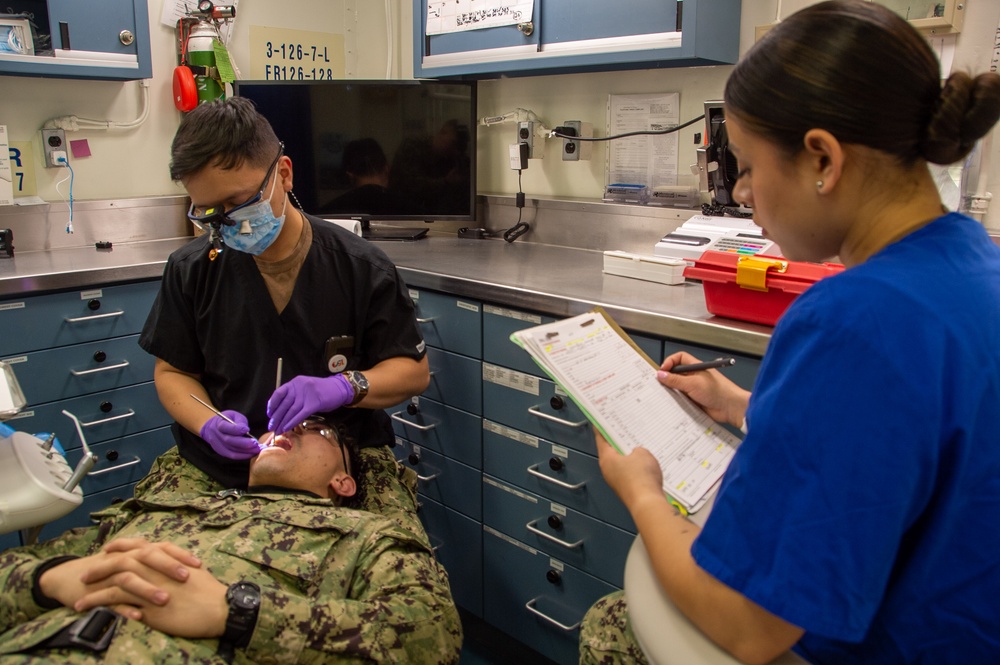 USS Ronald Reagan (CVN 76) Sailors conduct a dental examination