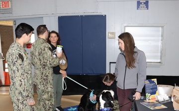 U.S. Sailors visit the Mutts With A Mission Table