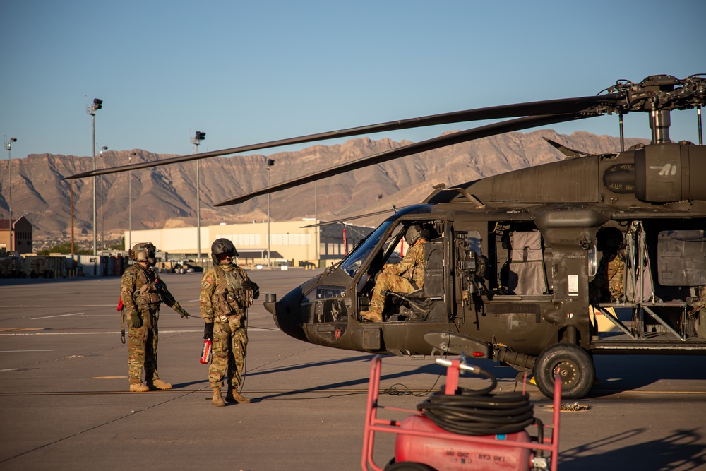 U.S. Army UH-60M Black Hawk crews conducts pre-flight checks