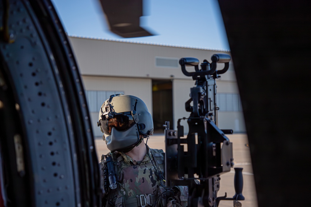 U.S. Army Door Gunner conducts pre-flight check