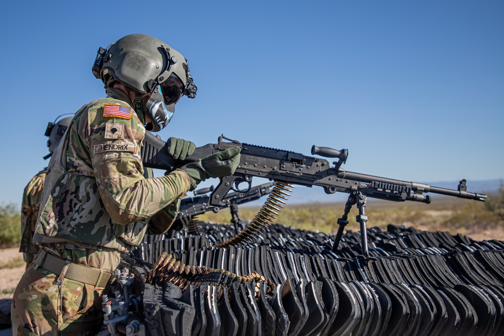 U.S. Army Door Gunner loads a M240B